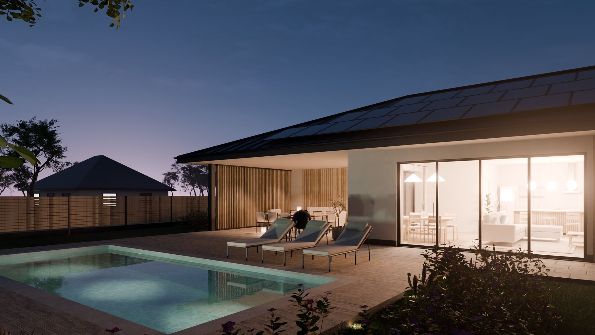 The lit terrace and living room reflected in the pool, a blue sky after sunset above the hipped roof.